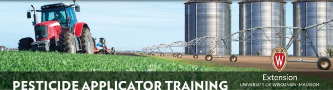 image of three farm silos, a field watering unit on a farm crop field with a farm tractor 