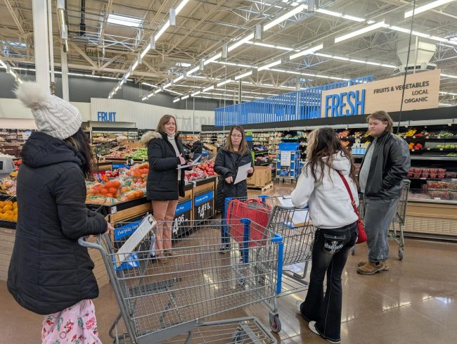 Teen Cuisine Coder 4-H members shopping for ingredients at the grocery store.